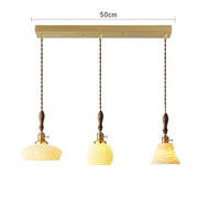 Suspension  design en céramique associant prise en cuivre et bois