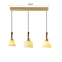 Suspension  design en céramique associant prise en cuivre et bois