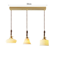 Suspension  design en céramique associant prise en cuivre et bois