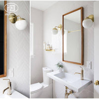 Applique murale dorée Bean, bras en verre à boule | Marco Lucetti