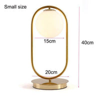 Lampe de chevet dorée avec boule en verre. | Marco Lucetti