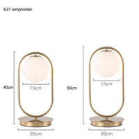 Lampe de chevet dorée avec boule en verre. | Marco Lucetti