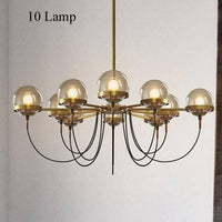 Lustre industriel doré avec boule en verre | Marco Lucetti 10 lampes