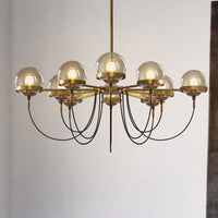 Lustre industriel doré avec boule en verre | Marco Lucetti