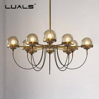 Lustre industriel doré avec boule en verre | Marco Lucetti