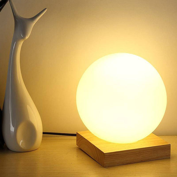 Lampe à poser LED design avec base en bois et boule en verre