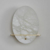 Applique murale LED ovale en marbre blanc et socle doré.