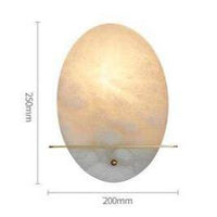 Applique murale LED ovale en marbre blanc et socle doré.