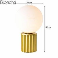Lampe à poser design dorée avec boule LED