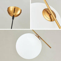 Suspension chic : barre dorée et boule en verre | Marco Lucetti