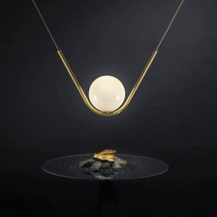 Suspension luminaire en métal doré et verre transparent | Marco Lucetti