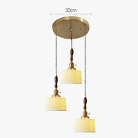 Suspension  design en céramique associant prise en cuivre et bois