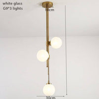 Suspension tube doré avec boules en verre contemporain | Marco Lucetti 3 lampes - blanc